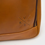 Close up of the Kovered logo on leather satchel 
