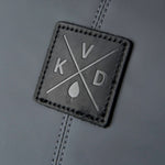 Square leather patch with 'KVD' logo on a gray background