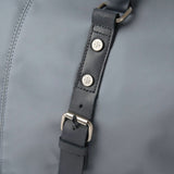 Close-up of a gray leather strap with metal buckles on a gray background