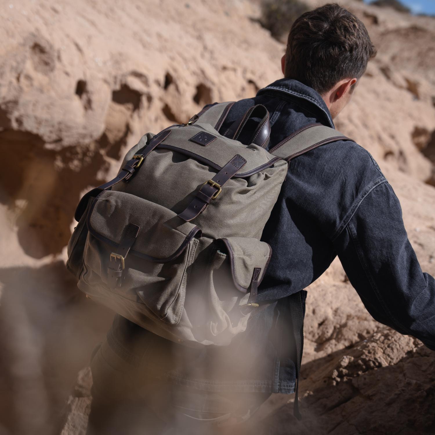 Man trekking wearing the canvas Lune backpack.