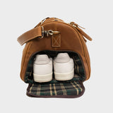 Open shoe compartment on Winster leather holdall with tartan lining