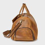 Side view of the Winster leather holdall with shoulder strap and zipped shoe compartment 