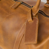 Close up of tan leather holdall luggage tag 