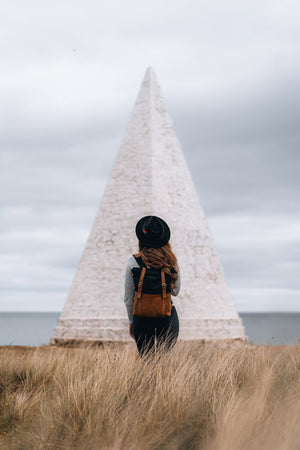 a woman wearing the kovered witham in black canvas and reclaimed leather looking out to sea 