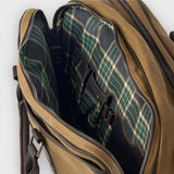Brown leather bag with plaid interior on a white background