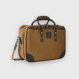 Brown travel bag with black accents on a light gray background