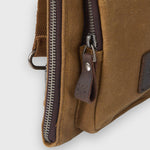 Brown leather bag with zipper on a white background