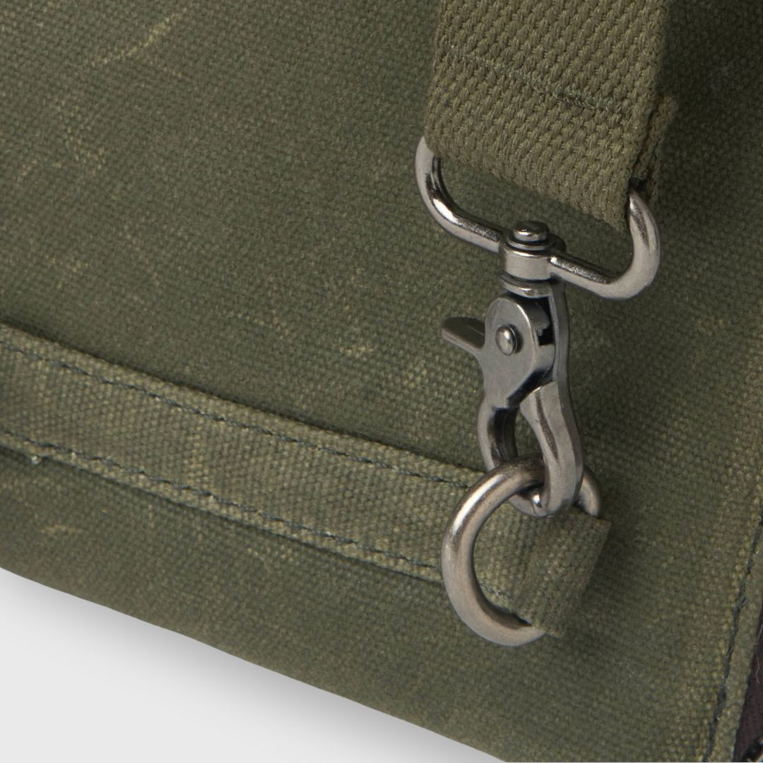 Close-up of a green bag with a metal clasp on a white background