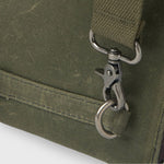 Close-up of a green bag with a metal clasp on a white background