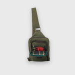 Green shoulder bag with plaid lining on a white background