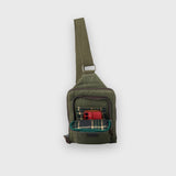 Green shoulder bag with plaid lining on a white background