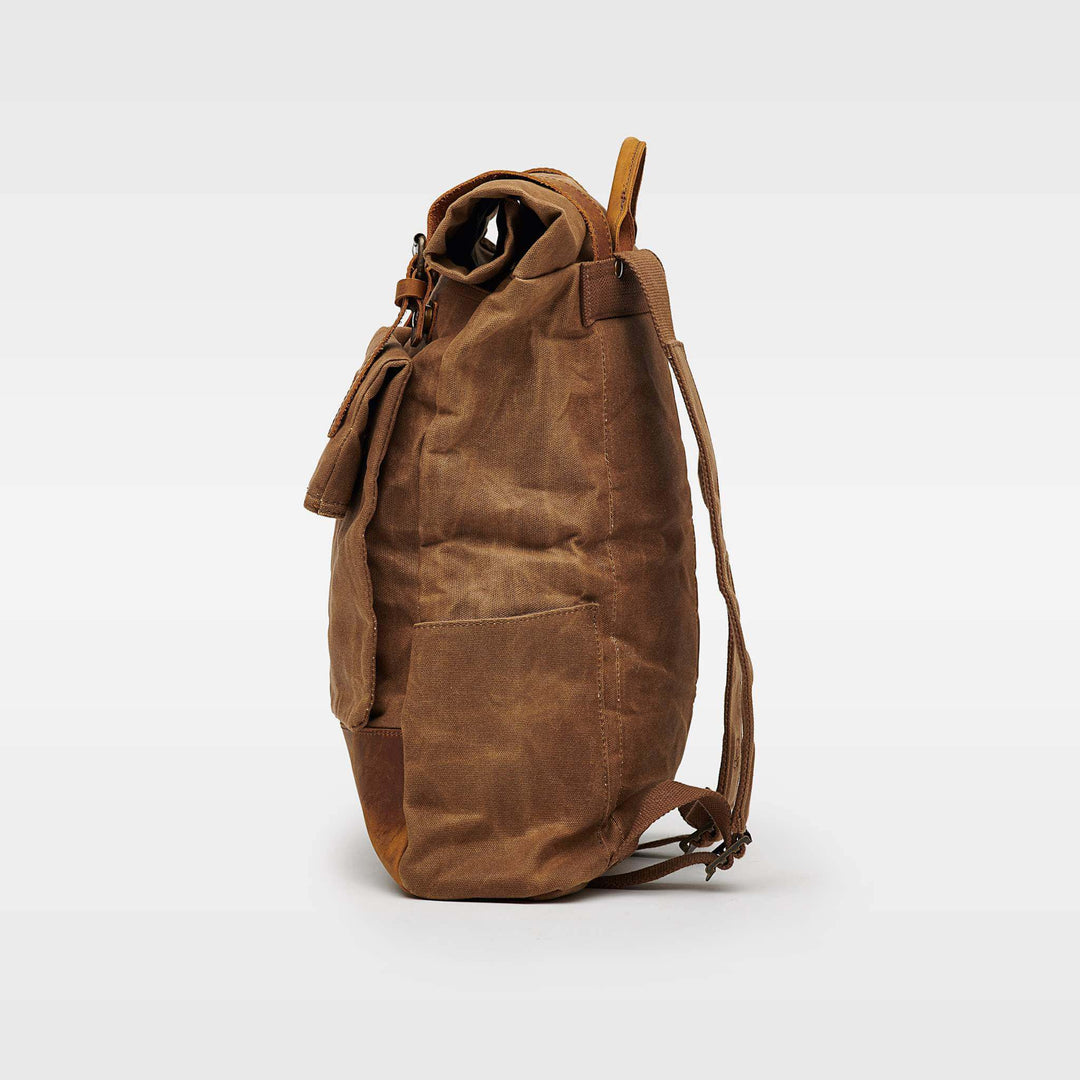 Taw tan waxed canvas rolltop backpack side view#colour_tan