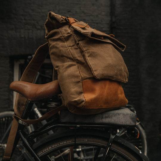 Taw Tan waxed canvas rolltop backpack on bicycle#colour_tan